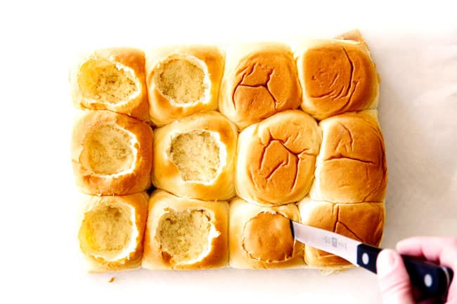 These Cheesy Italian Meatball Sliders are my favorite party food ever and my family loves them for dinner! The meatballs are the BEST (so tender and juicy!) and the marinara is amazing and I love how they are individual sliders instead of meatball subs! I can't recommend these enough! showing how to make meatball sliders by cutting the tops out of Hawaiian rolls