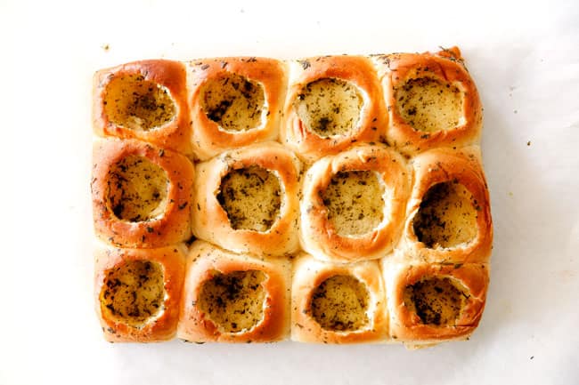 These Cheesy Italian Meatball Sliders are my favorite party food ever and my family loves them for dinner! The meatballs are the BEST (so tender and juicy!) and the marinara is amazing and I love how they are individual sliders instead of meatball subs! I can't recommend these enough! showing how to make meatball sliders by baking Hawaiian rolls until golden