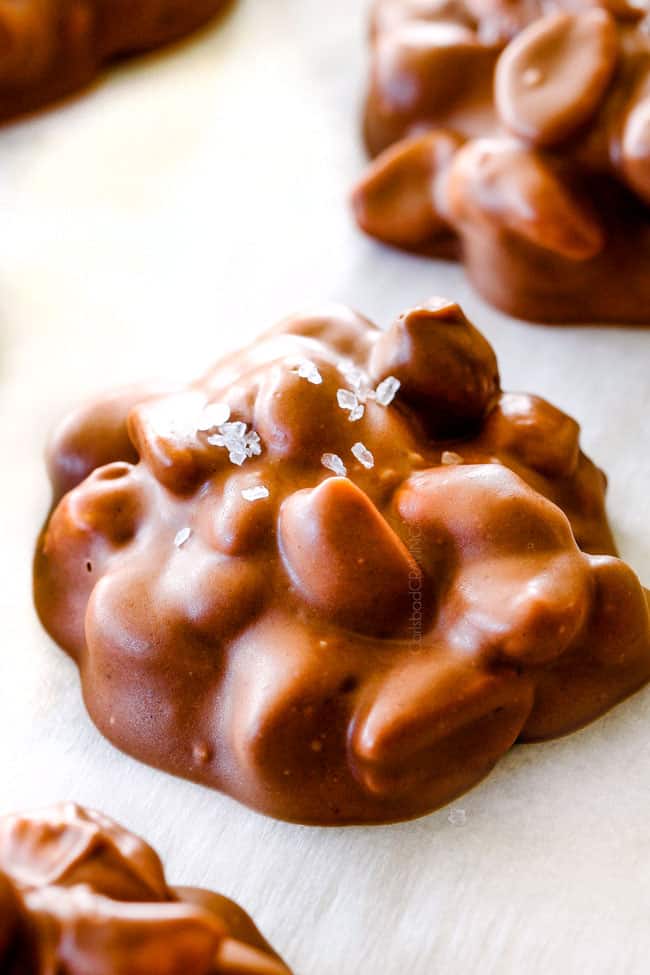 FOOL PROOF Crockpot Chocolate Peanut Clusters are not only crazy delicious but are SO easy! They make the best make ahead, stress free gifts! This post also includes tips and tricks to make them successful every time!