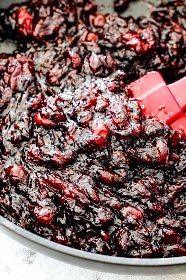 Rich and creamy Baked Brie in Puff Pastry is always a total luxuriously tasting crowd pleaser with minimal effort! (step by step pictures included) It can be prepped in advance then baked when you're ready for company! aaaaaaaaa showing how to make baked brie in puff pastry by simmering pepper jelly jam