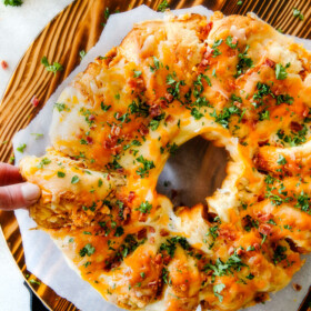 Mega flavorful Buffalo Chicken Dip Ring is your favorite decadent creamy, cheesy dip baked right into a buttery biscuit ring! Crazy delicious EASY crowd pleasing appetizer perfect for parties or game day! It may look super impressive but you won’t believe how easy it is!