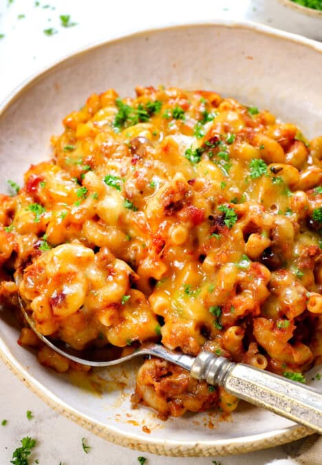 chili mac and cheese being served garnished with parsley