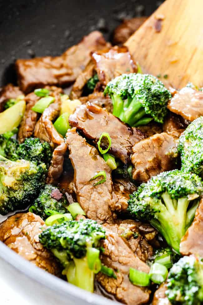 side view of Chinese beef and broccoli in a black skillet