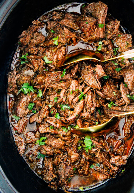 This is the BEST Slow Cooker Barbacoa Beef I have ever tried! Super tender, juicy, EASY and bursting with rich, complex flavors! Great for large crowds or make ahead meals and makes the best tacos, burritos, nachos, salads, etc!