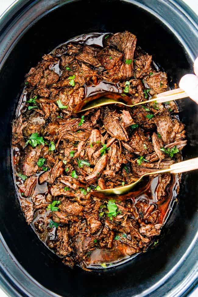 This is the BEST Slow Cooker Barbacoa Beef I have ever tried! Super tender, juicy, EASY and bursting with rich, complex flavors! Great for large crowds or make ahead meals and makes the best tacos, burritos, nachos, salads, etc!