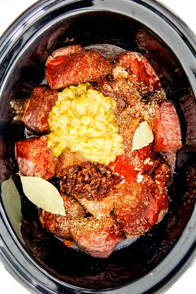 Showing how to make Chipotle Beef Barbacoa in a black pot.