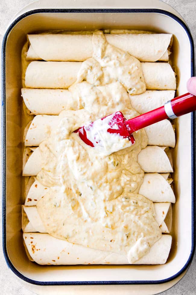 showing how to make Green Chile Chicken Enchiladas by adding sauce on top of enchiladas