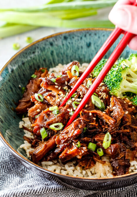 eating Vietnamese Caramelized Pork in green bowl with chopsticks