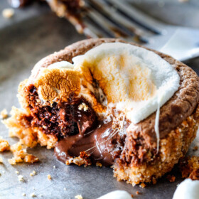 EASY - 30 Minute - S'mores Molten Lava Pies are decadently rich, with an oozing chocolate center, topped with melty toasted marshmallows all nestled in a buttery graham cracker crust - BUT - they are super easy to make and baked in a muffin tin so no special equipment is required!
