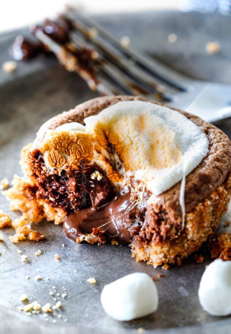 EASY - 30 Minute - S'mores Molten Lava Pies are decadently rich, with an oozing chocolate center, topped with melty toasted marshmallows all nestled in a buttery graham cracker crust - BUT - they are super easy to make and baked in a muffin tin so no special equipment is required!
