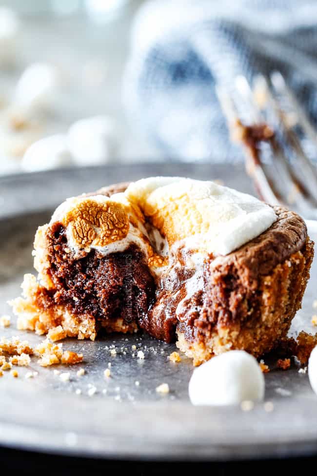 EASY - 30 Minute - S'mores Molten Lava Pies are decadently rich, with an oozing chocolate center, topped with melty toasted marshmallows all nestled in a buttery graham cracker crust - BUT - they are super easy to make and baked in a muffin tin so no special equipment is required!