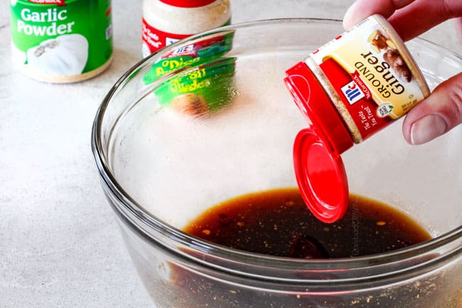 showing how to make Honey Soy Glaze in a glass bowl by adding soy sauce, honey and ginger