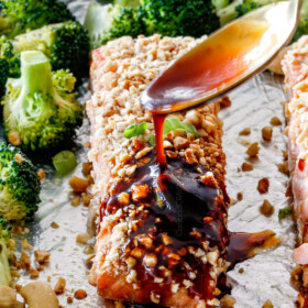 Drizzling honey soy glaze on Cashew Crusted Honey Soy Salmon