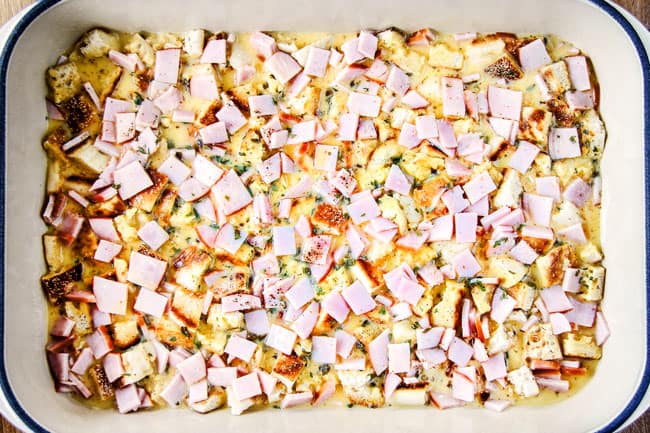 Showing how to make Eggs Benedict Casserole by pouring egg mixture over Canadian Bacon and English Muffins in casserole Dish