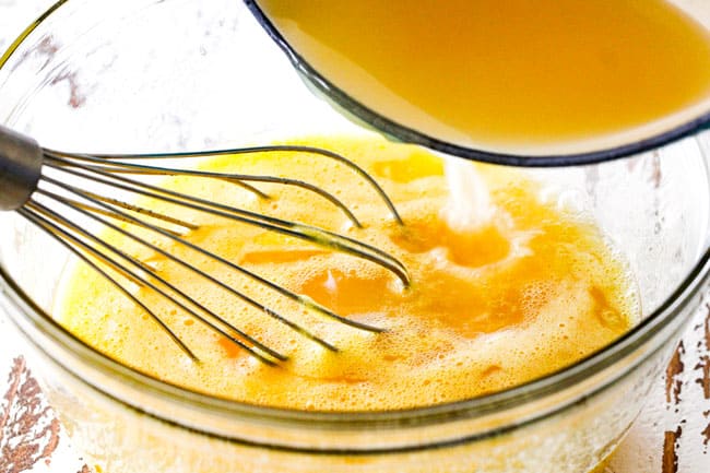 Showing how to make Lemon Curd for Lemon Blueberry Cake by whisking lemon juice into eggs and sugar in a glass bowl