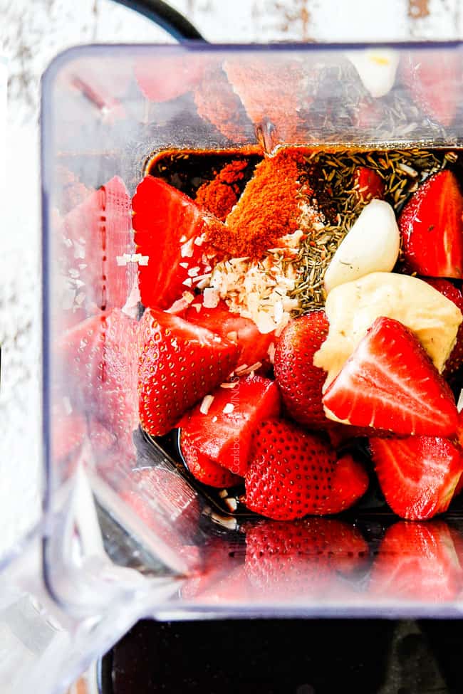 Showing how to make strawberry balsamic vinaigrette with strawberries, garlic, balsamic, dijon in a blender