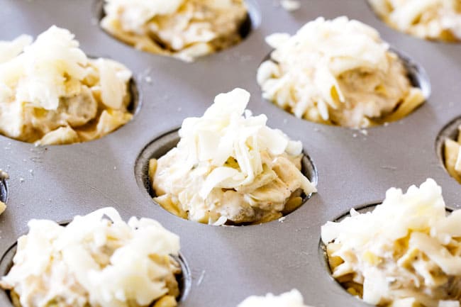Showing how to make Artichoke Dip Bites by adding Artichoke Dips to puff pastry dough in muffin tin