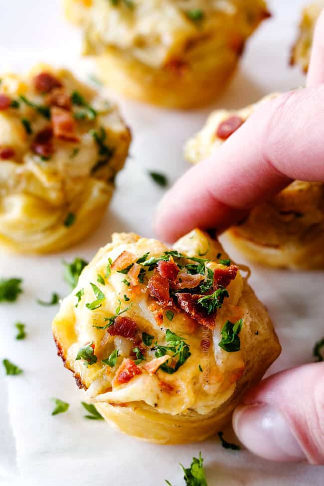 taking a bite of Artichoke Dip Bites