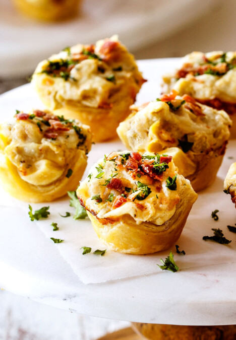 up close shot of Artichoke Dip Bites with parsley and bacon
