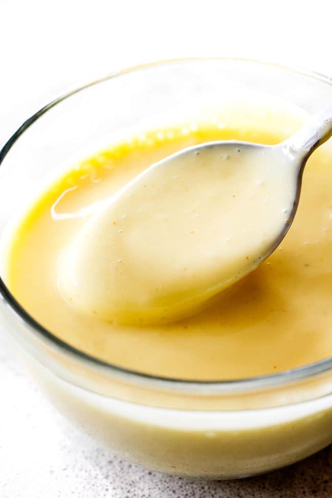 Showing how to make Blender Hollandaise Sauce by adding additional lemon juice to taste