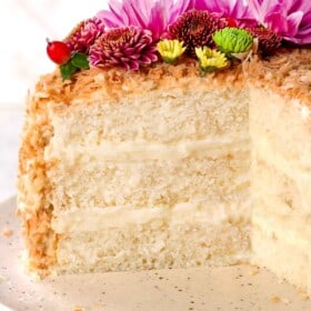 showing how to make coconut cake by frosting the outsides and pressing in toasted shredded coconut