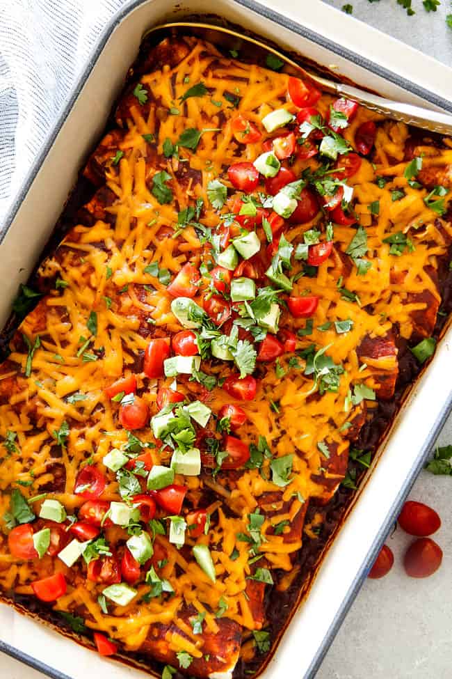cheesy Beef Enchiladas in a white baking dish