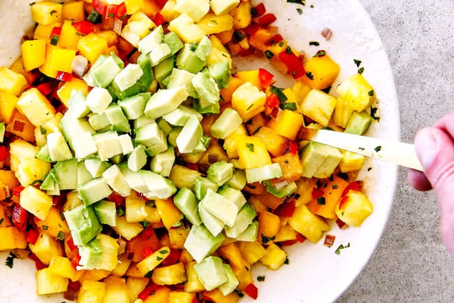 pineapple, mango, avocado salsa in a white bowl