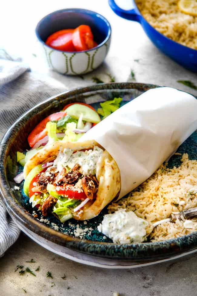 Greek Gyro with lemon rice and Greek salad on a blue plate