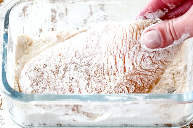 showing how to make easy chicken Parmesan by dipping chicken in flour in a glass shallow dish