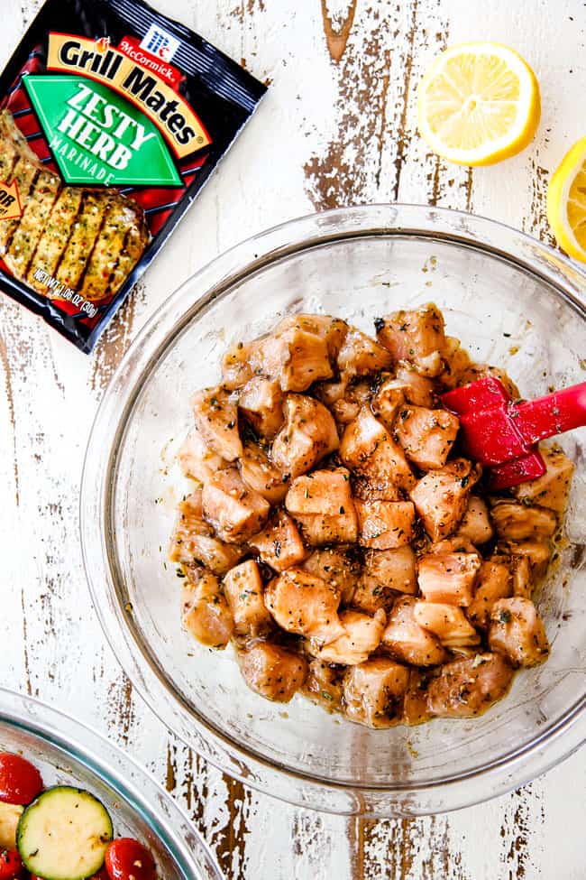 chicken in a glass bowl marinating to make chicken souvlaki