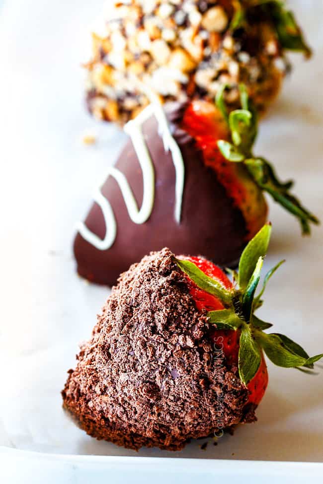up close of Chocolate Covered Strawberry coated in crushed chocolate graham cracker on Parchment paper