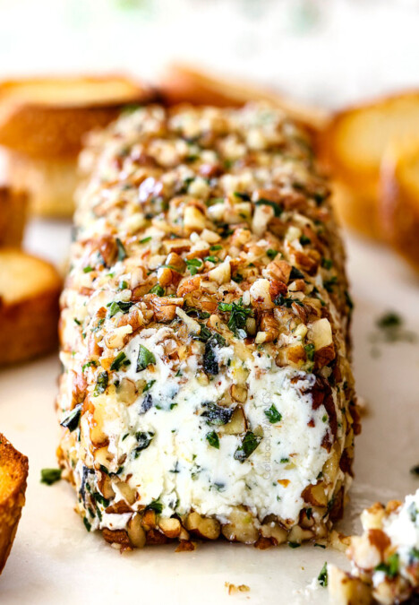 front shot of goat cheese log with garlic, zemon zest, basil, chives, parsley and rolled in pecans