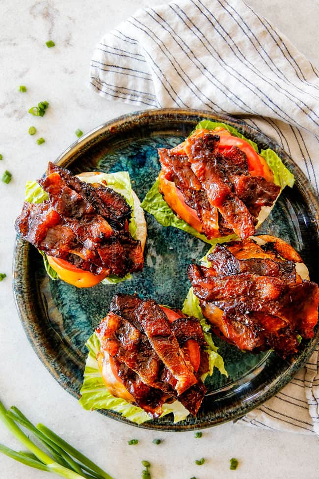 4 open faced bacon cheeseburgers with lettuce and tomatoes