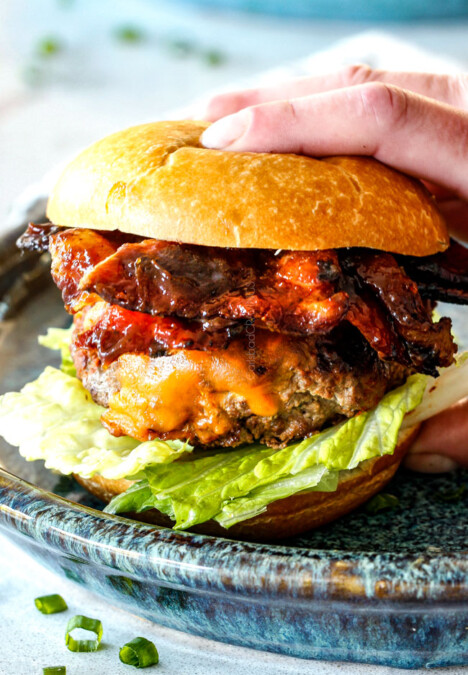 picking up a Korean BBQ Burger with bacon, lettuce and tomatoes