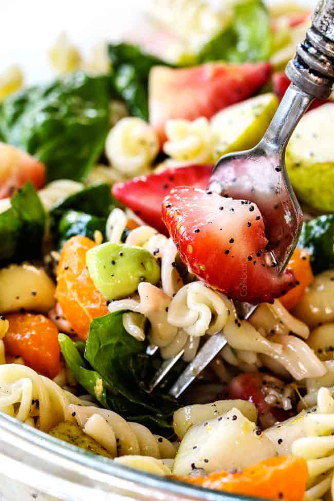a forkful of strawberry avocado pasta salad