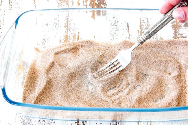 whisking together cinnamon and sugar in a shallow glass dish Showing how to make coating for churros