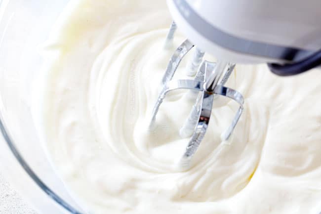 showing how to make grape salad by beat cream cheese, sour cream and sugar until smooth in a glass bowl