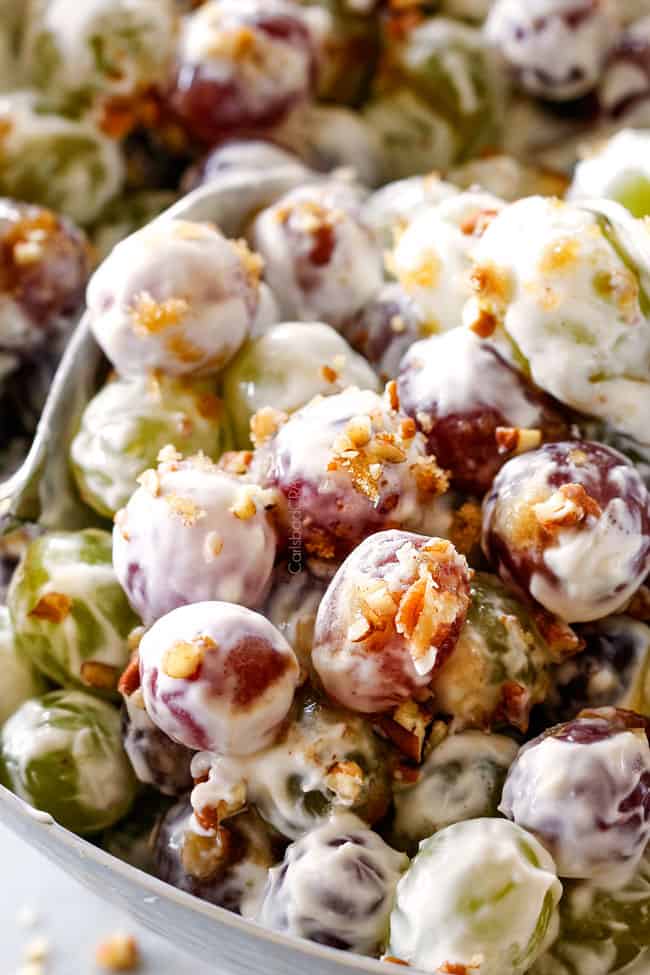 up close of best grape salad with silver tongs