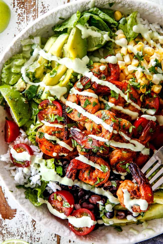 top view of a shrimp bowl with corn, tomatoes, avocado and shrimp drizzled with Cafe Rio Cilantro Lime Dressing