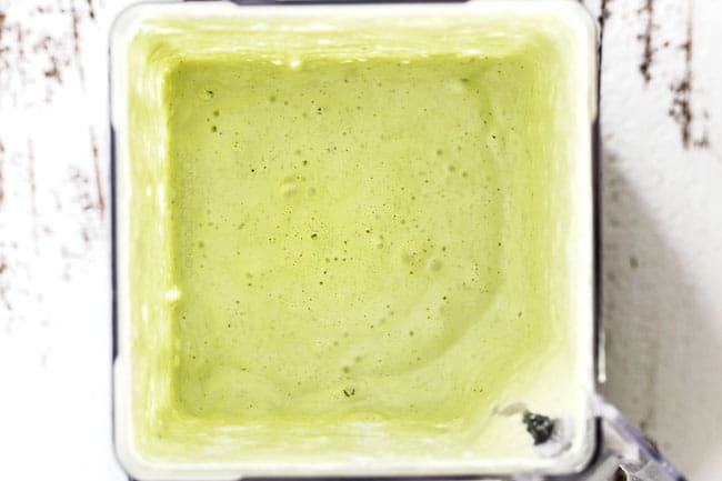 top view of creamy Cilantro Lime Dressing in a blender showing after it was just blended
