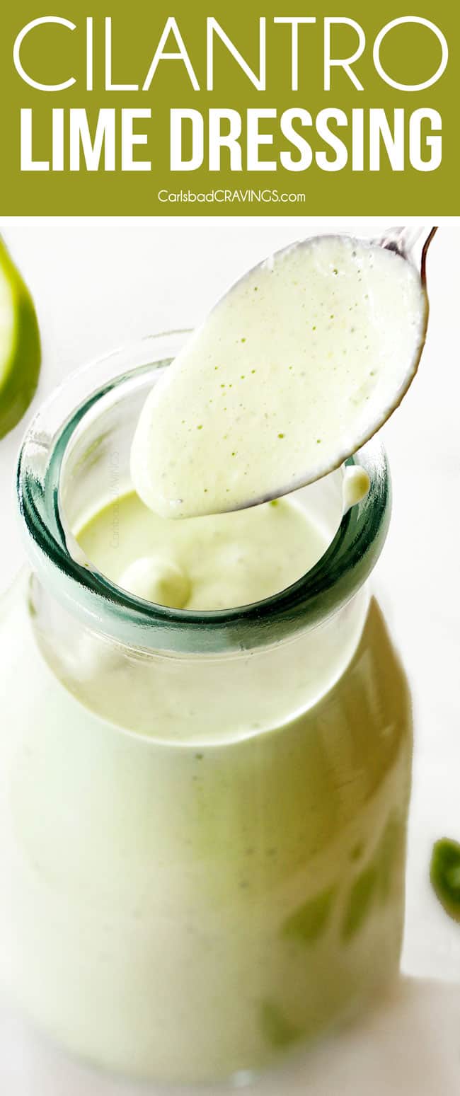 spooning creamy Cilantro Lime Dressing out of a jar