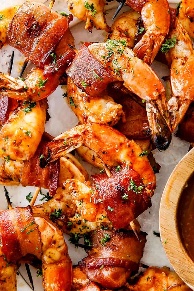 top view of bacon wrapped shrimp on a white platter