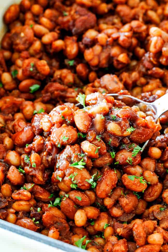 Scooping Homemade Baked Beans with a silver spoon