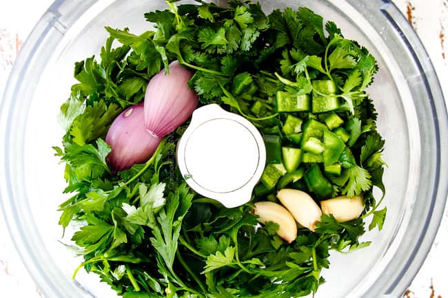 showing how to chop chimichurri for Chimichurri Steak by chopping parsley, cilantro, garlic shallot in food processor
