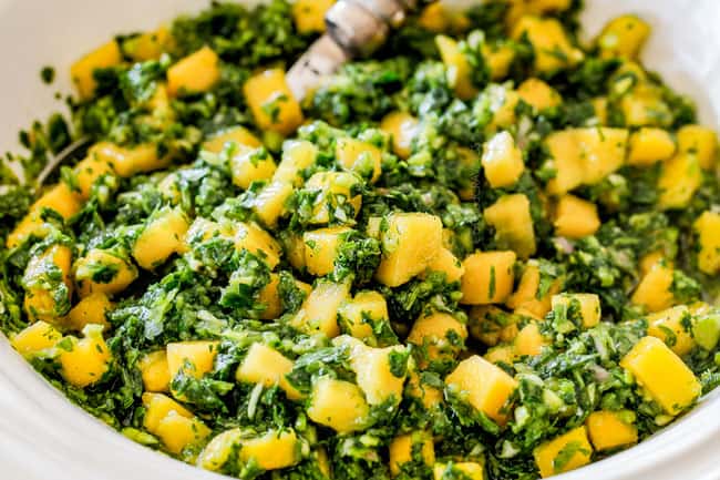 chimichurri in a white bowl with a silver spoon for Chimichurri Steak