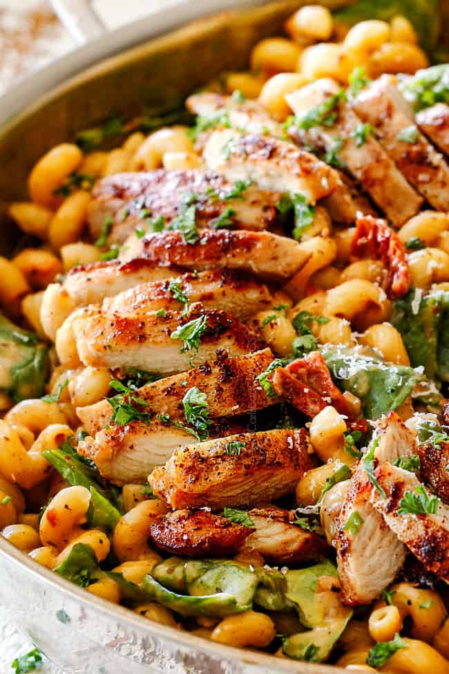 up close view of spice rubbed chicken in creamy Sun-dried tomato pasta