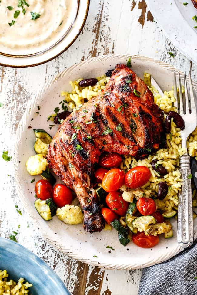 top view of Grilled tandoori Chicken with Indian rice and roasted tomatoes