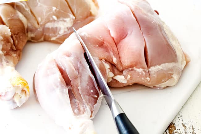 Showing how to make Tandoori Chicken at home by slashing chicken to the bone with a knife