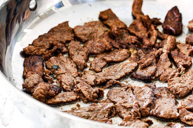 cooking beef bulgogi in a stainless steal pan to caramelize edges