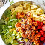 Top view of easy Shrimp Pasta salad with tortellini, lettuce, tomatoes and shrimp